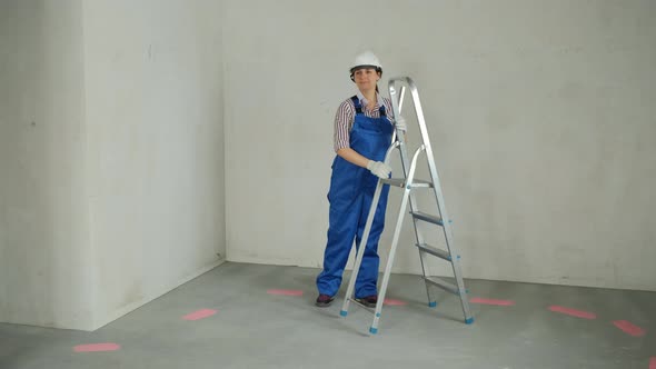 Female with Ladder Preparing for Renovating House alt