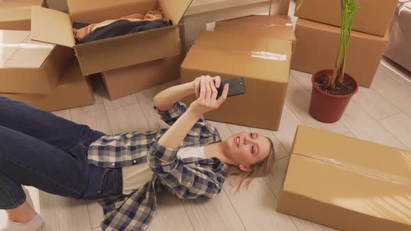 The Woman Took a Break Lying on the Floor Communicating By Video Link