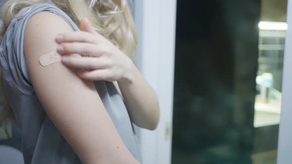 The Girl Looks at Herself in the Mirror Examines Herself a Plaster on Her Hand