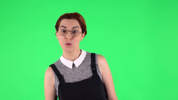 Portrait of Funny Girl in Round Glasses with Surprised Wow Face Expression. Green Screen alt