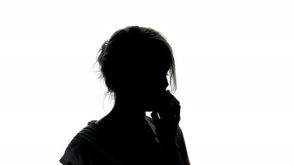 Woman in Silhouette Talking on the Phone