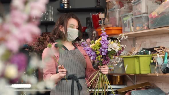 Woman Florist Is Making Composition of Fresh Flowers During Working Day at Store.