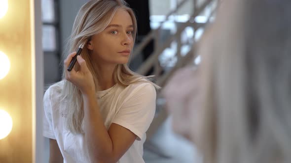 Blond Woman Applying Make Up