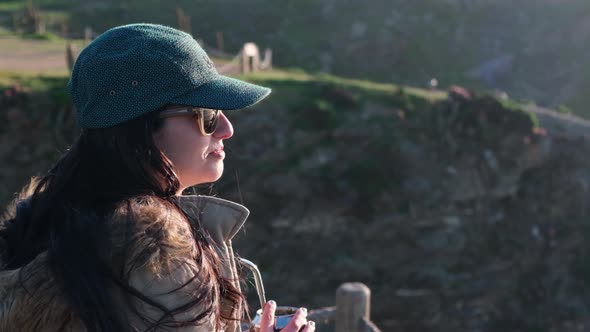 woman drinking yerba mate, typical Argentine drink, on the beach, while watching the sunset alt
