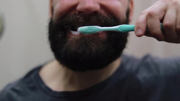Man brushing his teeth with toothpaste
