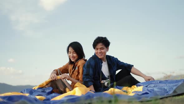 Happy woman talking with boyfriend while sitting outdoor a beautiful place. alt