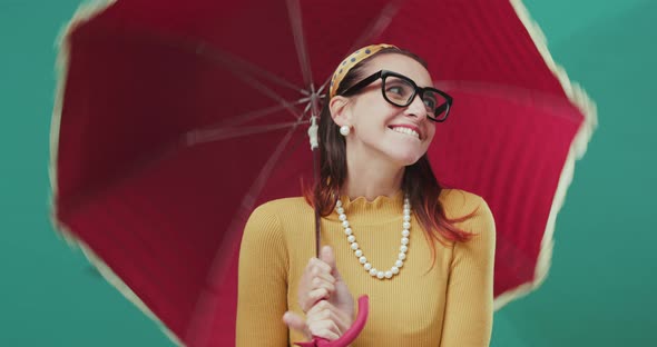 Happy woman holding a red umbrella