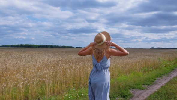 Happy Blonde Lady in Sundress Runs Across Field alt