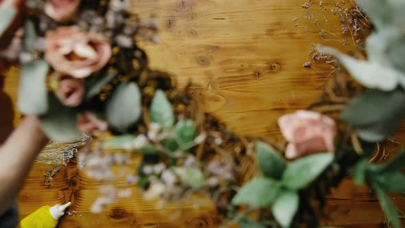 DIY Home Decor Crafts Hands Puts Spring Floral Wreath on Table alt