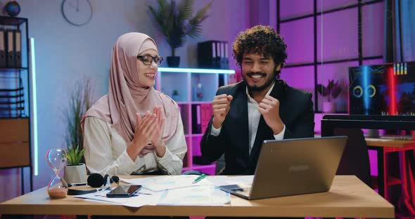 Businesspeople Clapping Hands and Giving High Five Each other when See Good News on Laptop Screen alt