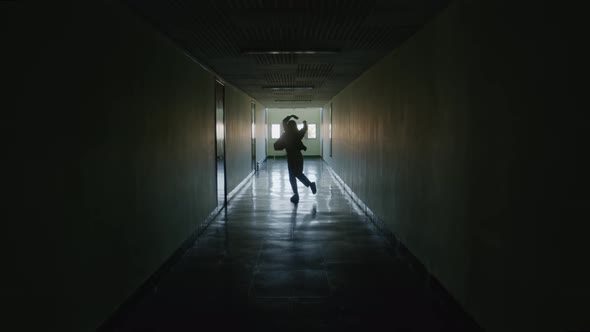 Woman Dancing Contemporary Dance In Dark Hallway