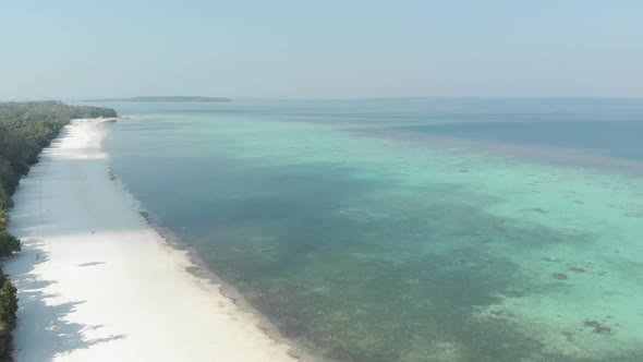 Aerial: flying over desert tropical beach in the Moluccas archipelago, Indonesia alt