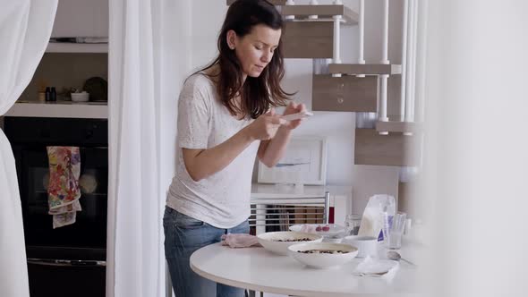 Food blogger taking pictures of plates at home alt