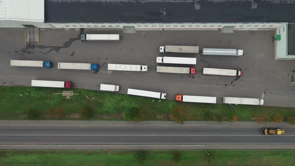 trucks waiting to be loaded at the logistics center top view.