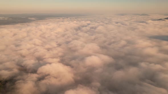 4K Aerial video Beautiful sunrise above dense clouds and fog in the morning, Cinematic drone shot. alt