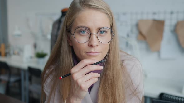 Creative Clothes Designer Thinking About New Collection Then Looking at Camera and Smiling Indoors alt