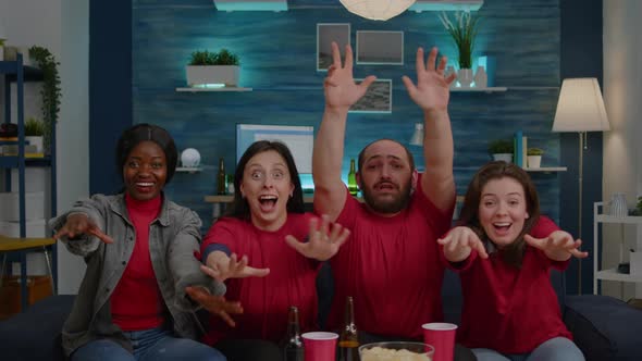 Excited Mixed Race Fans Having Fun While Looking at Football Match alt