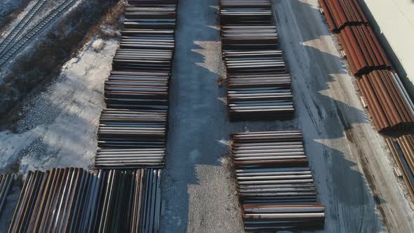 Round metal pipes in Metal warehouse. Industrial outdoors storage site. Drone view. 06 alt