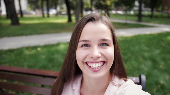 Young woman smiling while video conference with friends. Tourist making video calling. alt