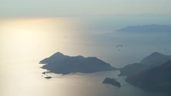 Paragliders Flying With Paragliding in Sky Over the Forest, Mountain Top and Sea alt