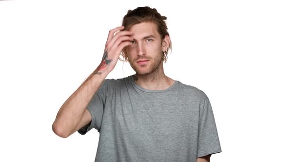 Portrait of Attractive Stylish Guy with Tattoo on His Neck Smiling and Putting in Order His Messy alt