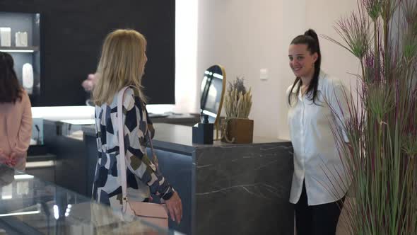Smiling Seller Greeting Customer in Jewellery Shop Indoors alt