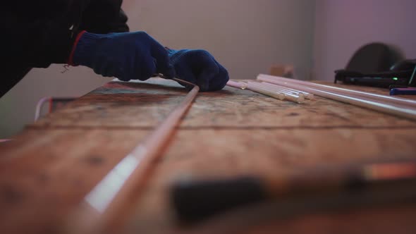 Male Hands in Gloves Preparing Neon Lightbulbs for Making Neon Close Up Shot Slow Motion alt