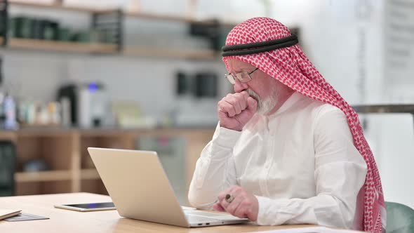 Sick Senior Old Arab Businessman with Laptop Coughing alt