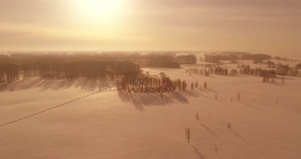 Aerial View of Cold Winter Landscape Arctic Field Trees Covered with Frost Snow Ice River and Sun alt