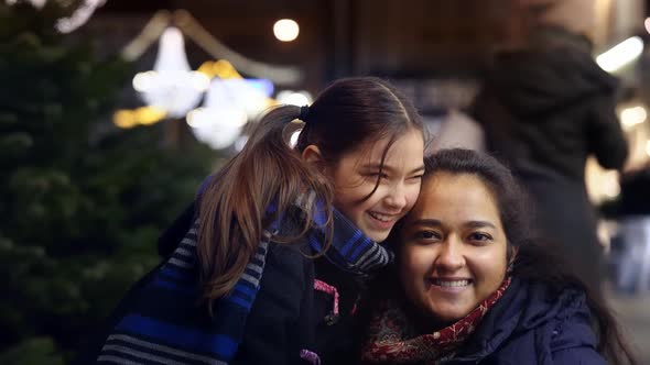 Cheerful Little Girl and Her Mother at Christmas