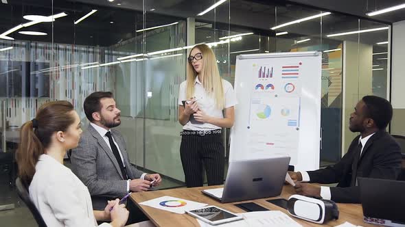 Female Office Worker Reporting about the Results of Work Done to Her Male Business Leader alt