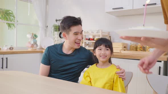 Asian attractive LGBTQ gay family celebrate birthday girl kid in house. alt