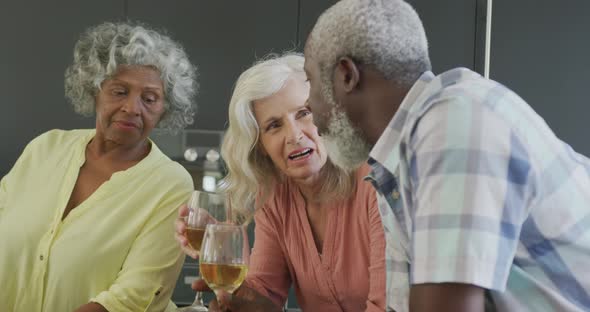 Happy senior diverse people cooking in kitchen at retirement home alt