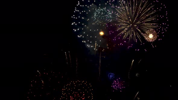 Many flashing colourful fireworks in event amazing with black background.