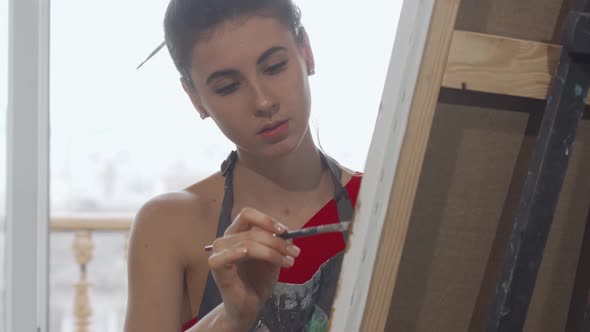 Sliding Shot of a Gorgeous Young Woman Drawing a Picture at Art Studio alt
