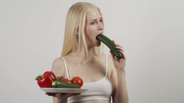 Young Sporty Blonde Woman in Underwear with Vegetables Isolated on White Background alt