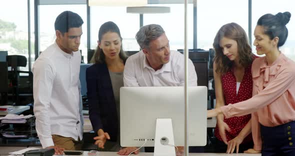 Business people working together on computer at desk in a modern office 4k