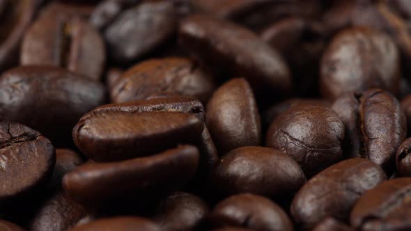 close up of roasted coffee beans rotating, seeds of coffee