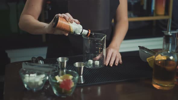 Female Professional Bartender preparing and serving Fresh Cocktails in bar club alt