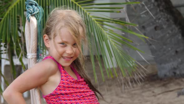 Smiling Girl Riding Around on Rope