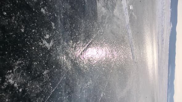 A Piece of Transparent Ice Breaks on the Surface of Lake Baikal and Crumbles Into Small Fragments in alt