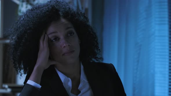 Portrait of Tired African American Woman Against the Background of Turning on and Off the Light alt