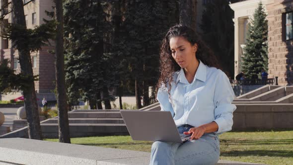 Serious Young Attractive Female Freelancer Worker Sitting Terrace in City Building Background Typing alt
