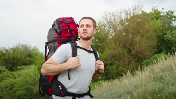 Happy Young Man in the Mountains He Rejoices Standing Against the Backdrop of a Beautiful Landscape