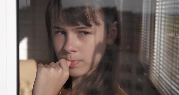 Teen Looking Out the Window alt