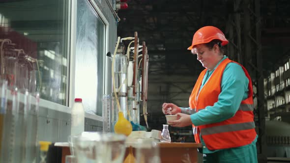 Mature Woman Working in Chemical Plant Focused Female Worker Wearing Hard Hat alt