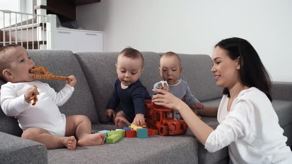 Filipino Nanny Playing with Triplets at Home alt
