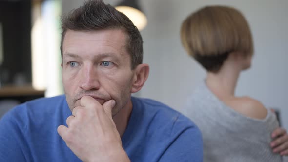 Headshot Sad Thoughtful Adult Man Looking Away As Blurred Woman Looking at Spouse Turning at alt