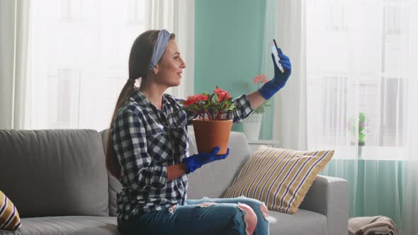 Woman Florist Is Streaming Live Video Using Gadget alt