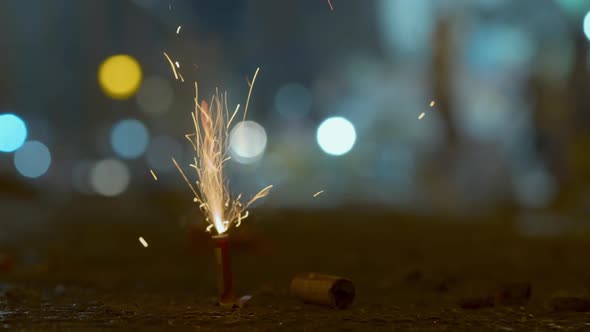 A Firecracker is Set on Fire on a City Street